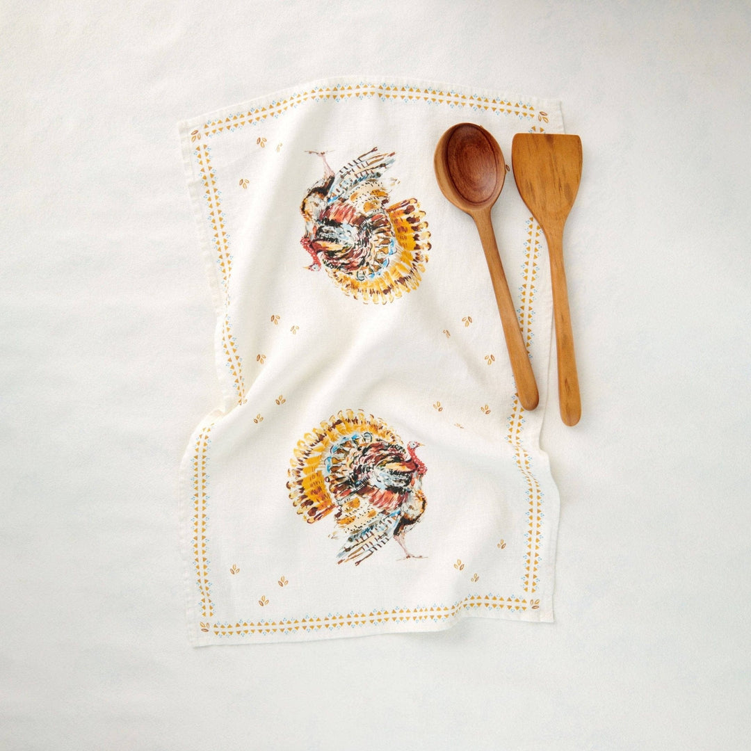 Turkeys Kitchen Towel with two festive and colorful turkeys and a dotted border with a wooden spoon and spatula on a white background