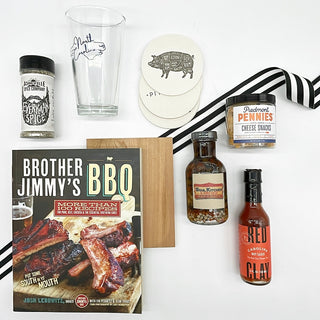 For your favorite grill master! We have packed this hamper full of some of our most favorite Carolina goodies. Included in a rattan hamper, you'll get: Everyman Spice from Asheville, a North Carolina pint glass, Piedmont Pennies from Charlotte, Red Clay Carolina Hot Sauce from Charleston, Soul Kitchen Pepper Vinegar from Raleigh, a cedar plank, pack of 8 barbecue coasters and Brother Jimmy's BBQ book. All the essentials for an afternoon by the grill!