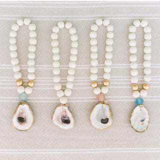 Adorn a room, shelf, doorknob, or table with coastal gratitude with the Oyster Blessing Beads.