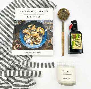 Gift for the gourmet includes Half Baked Harvest book, wooden olive spoon, olive oil and citrus scented candle