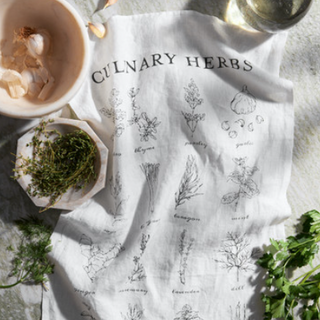 Culinary Herbs towel is printed using silk screens and cut from running yardage that comes off the loom with selvage sides before we hem it by hand.  • Design: Culinary Herbs • Color: Black/Oyster White • 18" x 28" • 100% Pure Linen • Hand-Screened in India